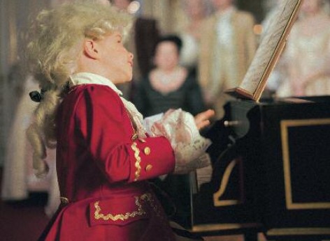 Perhaps young Wolfgang Amadeus Mozart looked like this? The image shows a young boy at a spinet, representing the young Wolfgang Amadeus Mozart, whose music is being performed in the classical concerts of the Schoenbrunn Palace Orchestra in the Orangery Vienna daily